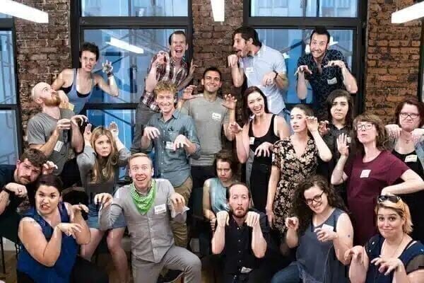 Group dressed casually making dinosaur poses and funny faces