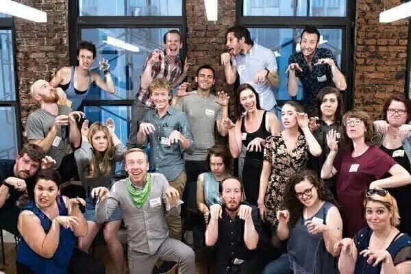 Group dressed casually making dinosaur poses and funny faces